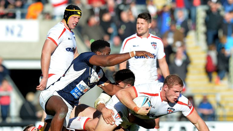 Tom Burgess is tackled by the French defence