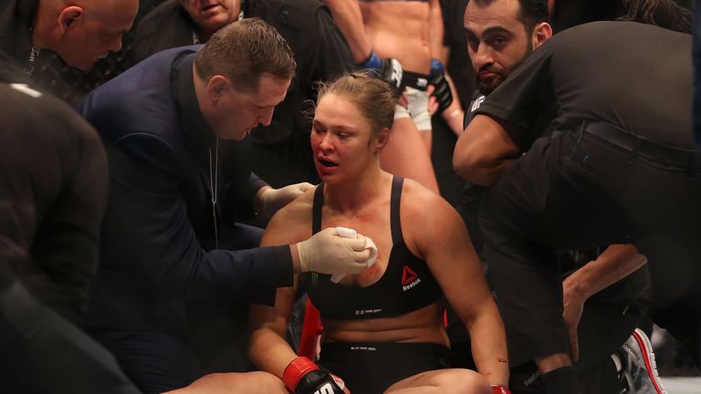 Rousey receives medical treatment after the defeat