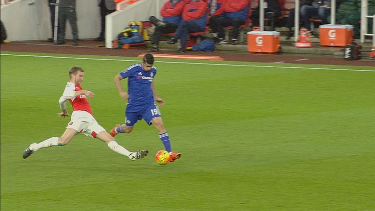 Per Mertesacker fouls Diego Costa during Arsenal's clash with Chelsea