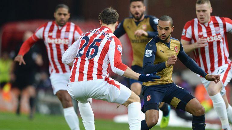 Theo Walcott takes on Stoke's Philipp Wollscheid