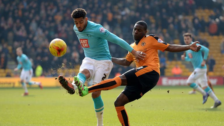 Jeremy Helan of Wolves tackles Derby's Cyrus Christie.