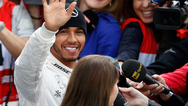 Hamilton waves to the fans during the lunch break