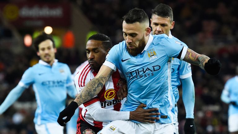 Nicolas Otamendi and Jermain Defoe compete for the ball