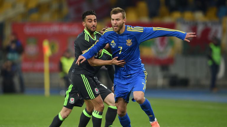 Yarmolenko and Wales' Neil Taylor (l) battle for the ball