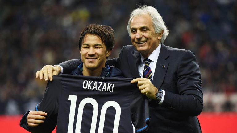 Okazaki poses for photographs with a shirt to mark his 100th appearance for Japan