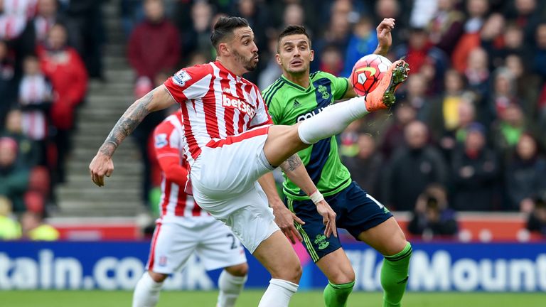 Geoff Cameron and Tadic compete for the ball in the first half