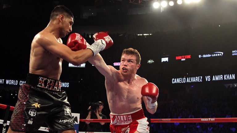 Saul Canelo Alvarez (R) connects a right against Amir Khan (L)