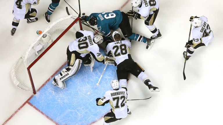 The Penguins combine to stop Justin Braun of the San Jose Sharks