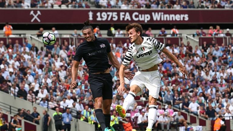 Andy Carroll (left) heads the ball toward goal before scoring