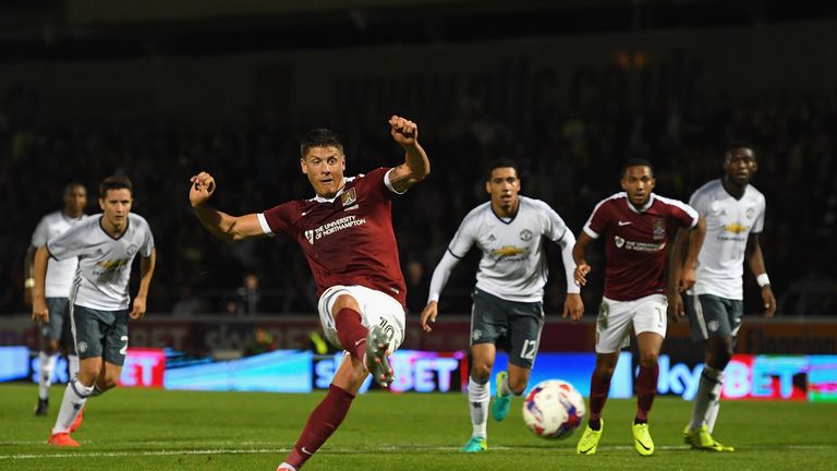Alex Revell of Northampton Town scores his side's first goal