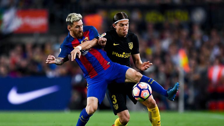 Messi battles with Filipe Luis at the Nou Camp