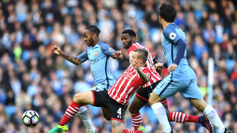 Raheem Sterling rides a challenge from Jordy Clasie