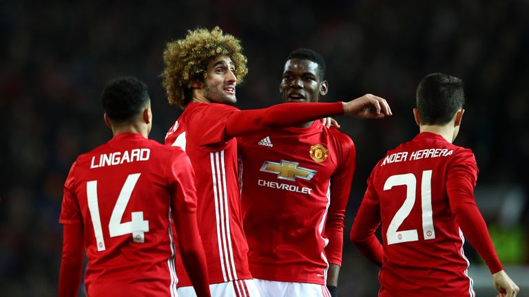 Fellaini celebrates with his team-mates after scoring against Hull