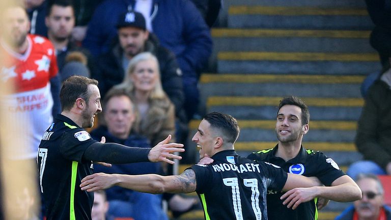 Brighton's Sam Baldock celebrates scoring his side's first goal with Glenn Murray (L) and Anthony Knockaert (C)