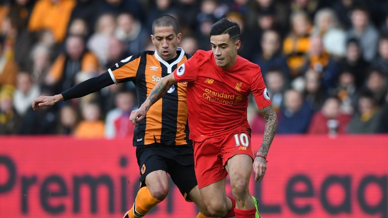 Philippe Coutinho looks to avoid Hull midfielder Evandro