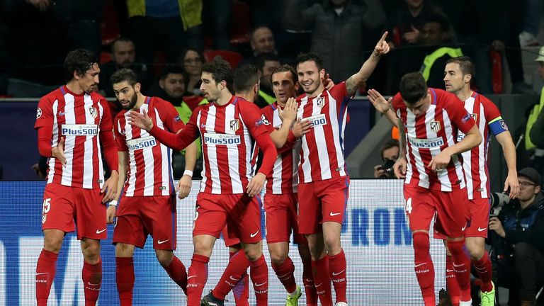 Atletico's players celebrate Saul's stunning opener at the BayArena