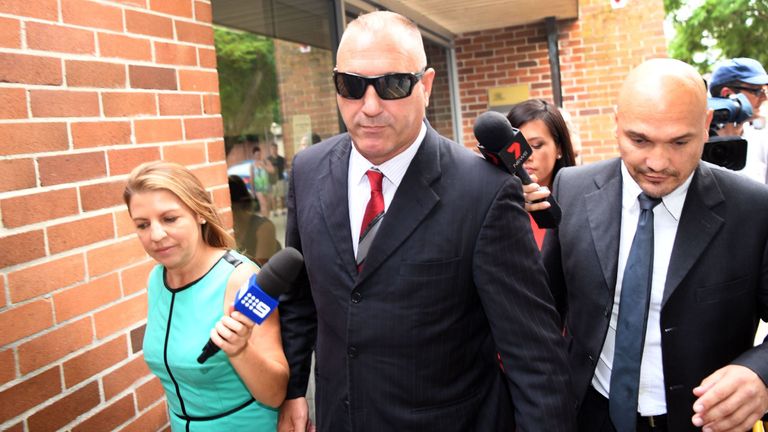 Security consultant Adrian Gard (middle) leaves court after appearing accused of bugging the All Blacks