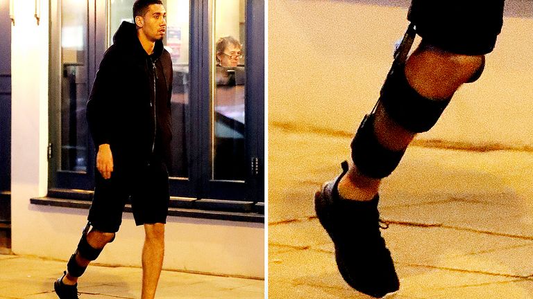 An injured Chris Smalling wearing a leg brace while out near Manchester (credit: Eamonn and James Clarke)