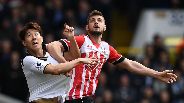 Heung-min Son and Jack Stephens tussle for possession of the ball