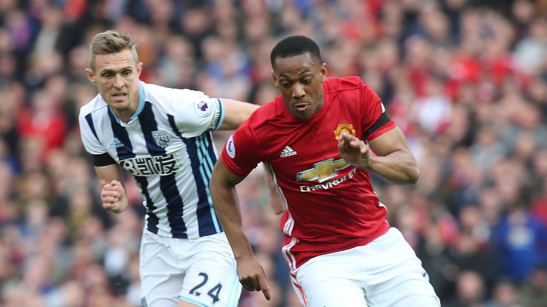 Manchester United striker Anthony Martial is challenged by West Bromwich Albion's Darren Fletcher