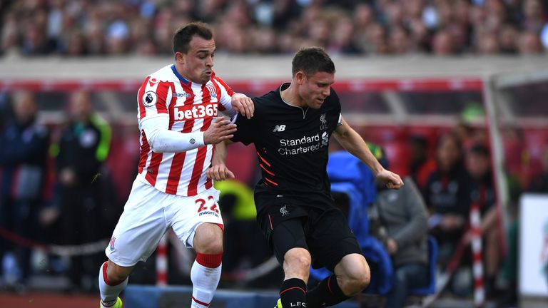 Xherdan Shaqiri battles with James Milner