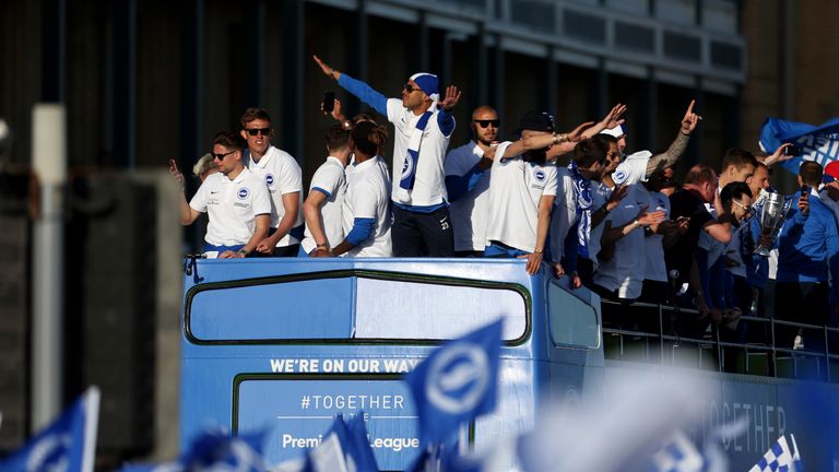 Brighton and Hove Albion players celebrate during the bus parade