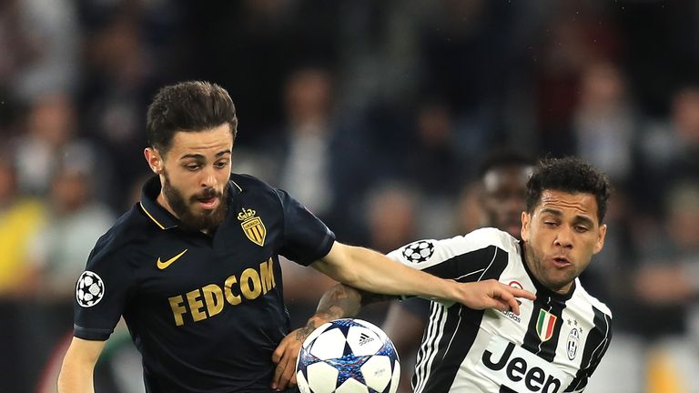 Bernardo Silva holds off Dani Alves in Turin