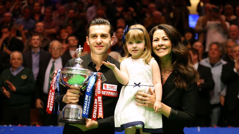 Selby celebrates with his daughter and wife
