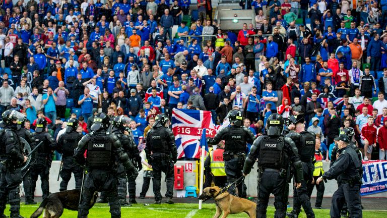 Police take up position at full time in front of the Linfield supporters in Belfast