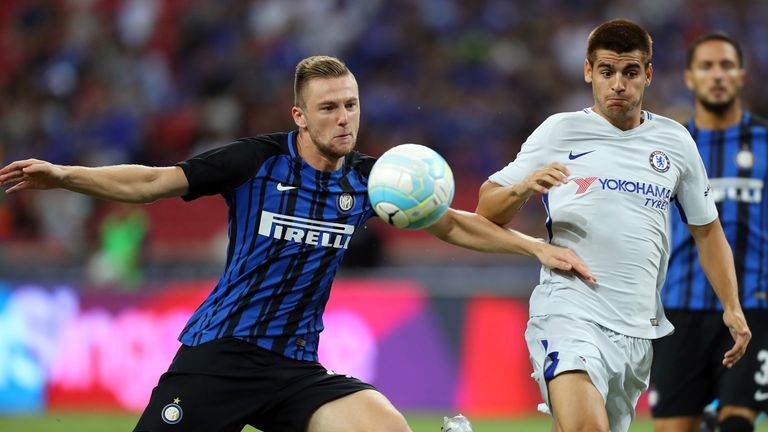 Milan Skriniar ushers the ball away from Alvaro Morata