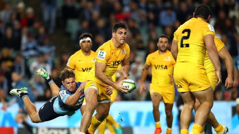 Pablo Matera looks to break free from the tackle of Michael Hooper