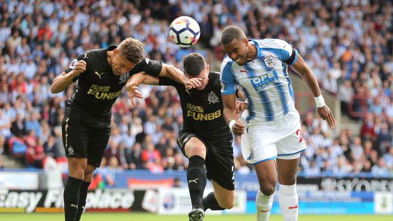 Mathias Jorgensen (right) battles with Dwight Gayle in the first half