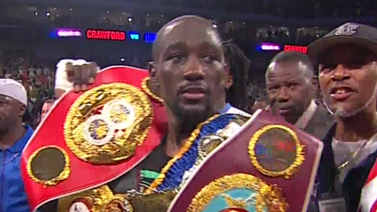 Terence Crawford poses with all four world titles