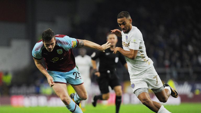 Kemar Roofe of Leeds and Kevin Long of Burnley challenge for possession