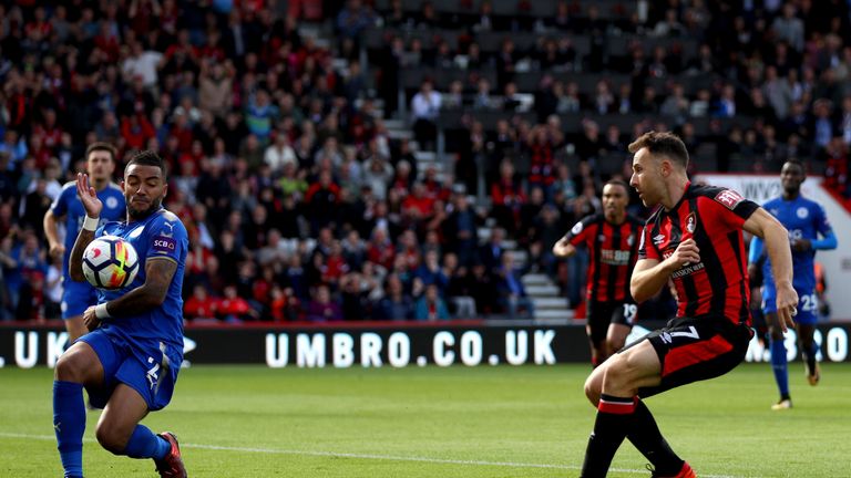 Leicester right-back Danny Simpson (left) appears to handle Marc Pugh's goal-bound shot