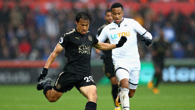 Shinji Okazaki (left) battles for possession with Luciano Narsingh
