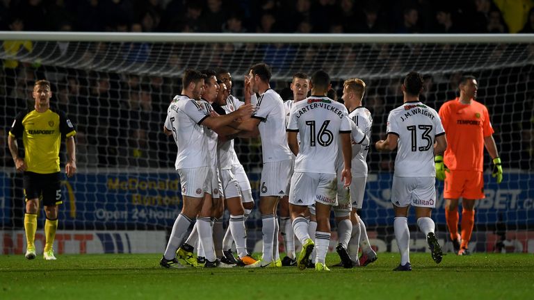 Billy Sharp scored twice in a win which sent Sheffield United top of the Championship