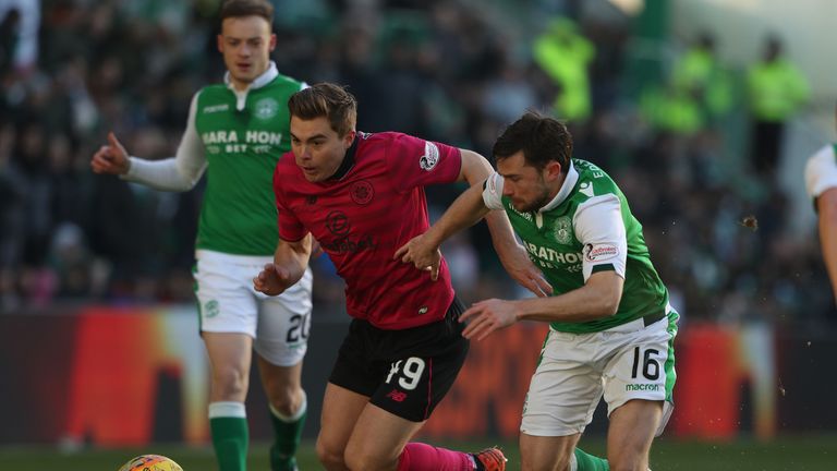 Hibernian's Lewis Stevenson battles the ball with Celtic's James Forrest (left)