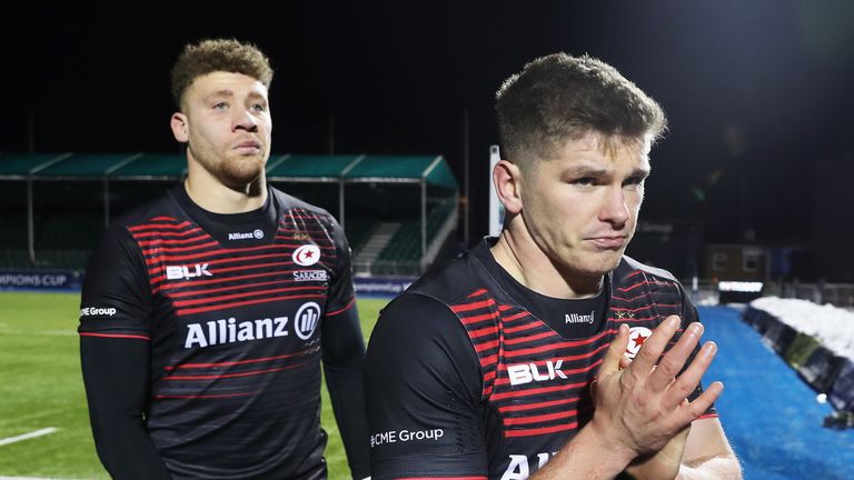 Owen Farrell (R) of Saracens leaves the field dejected after the final whistle