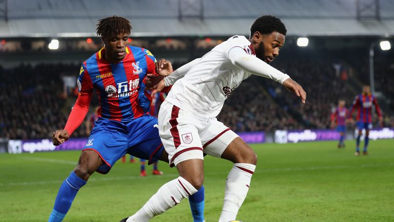 Georges-Kevin N'Koudou of Burnley is challenged by Wilfried Zaha of Crystal Palace