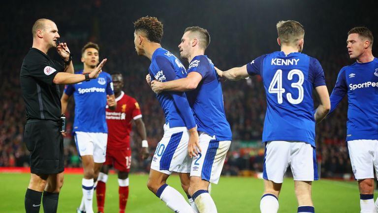 Holgate is restrained by Morgan Schneiderlin after a clash with Firmino