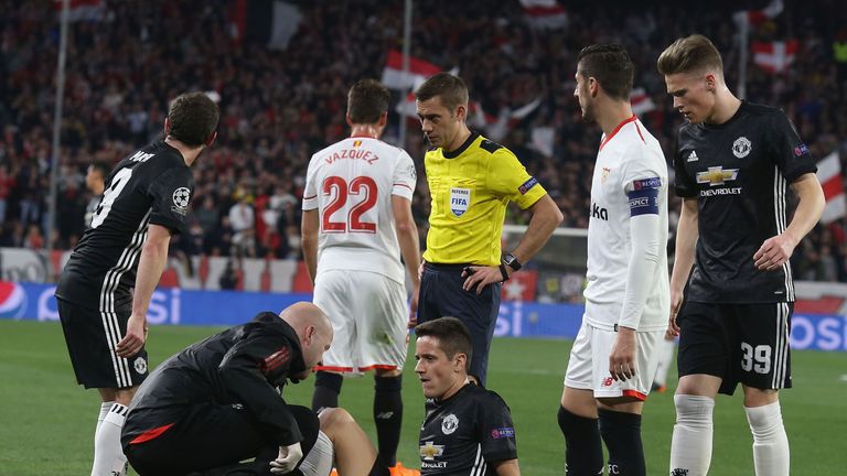 Manchester United midfielder Ander Herrera receives treatment on the pitch against Sevilla