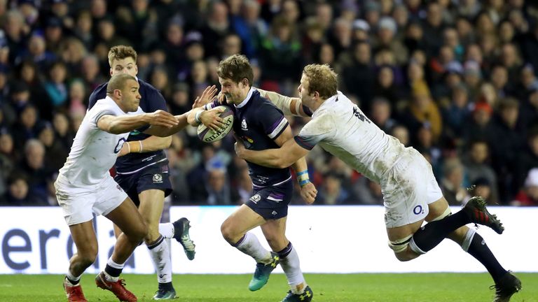 Peter Horne is tackled by England's Joe Launchbury (R) and Jonathan Joseph