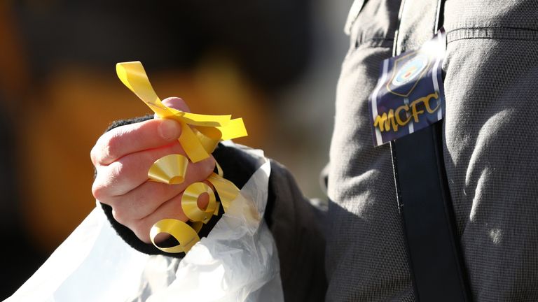 Yellow ribbons were handed out before the Carabao Cup Final between Arsenal and Manchester City