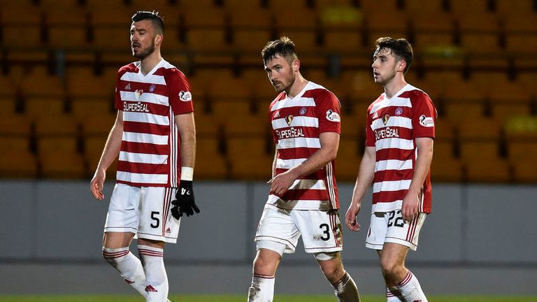 Hamilton's Xavier Thomas (left), Scott McMann and Darren Lyon leave the field dejected at full-time