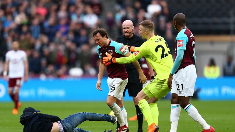 A supporter tussles with West Ham captain Mark Noble during Saturday's match