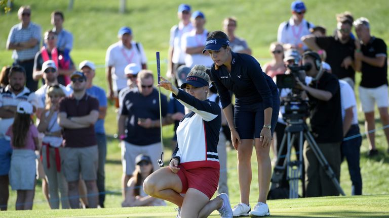 Charley Hull lines up a putt on the fifth green at the GolfSixes as Georgia Hall looks on