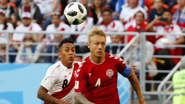 Peru midfielder Christian Cueva vies for the ball with Denmark defender Simon Kjaer