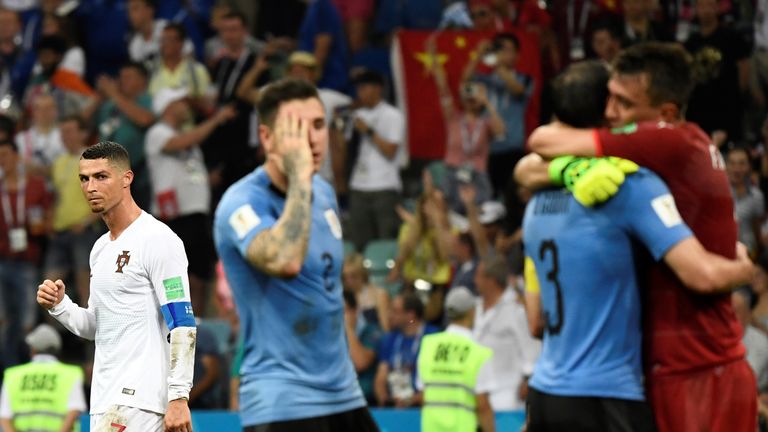 Cristiano Ronaldo looks on as Uruguay celebrate at the final whistle