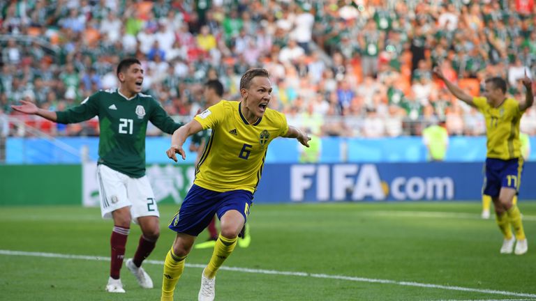 Ludwig Augustinsson wheels away from goal in celebration after scoring for Sweden
